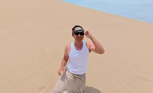 挑戰垂直趴在滑板上體驗高處滑沙。