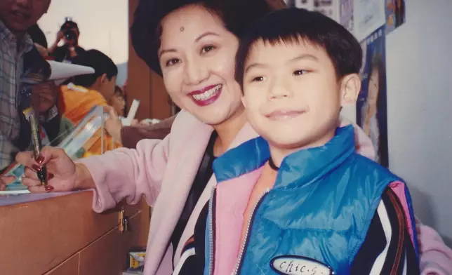 家燕與當年只有7歲的李國煒在維園攤位合照。（圖片由李有毅提供）