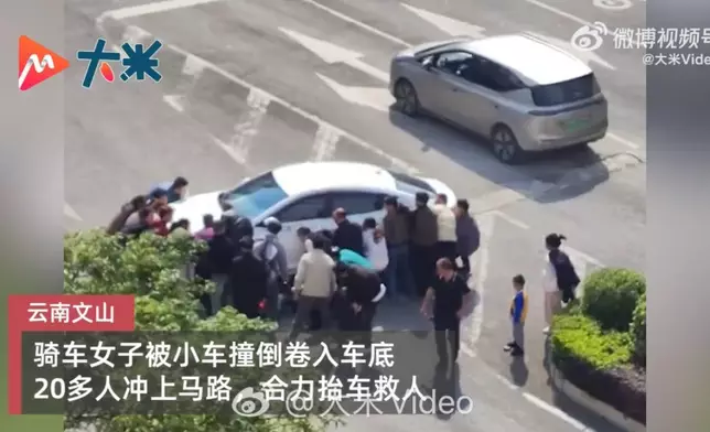 女子遭私家車撞倒捲入車底獲逾20名熱心民眾合力抬車救出送醫。影片截圖