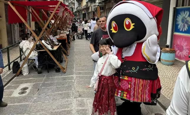 旅客與澳門旅遊吉祥物「麥麥」在行人專用區合照。澳門新聞局網站圖片