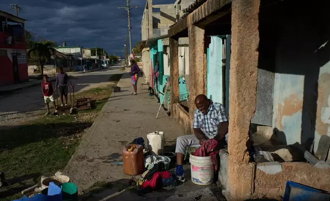 古巴聖克魯斯德爾諾特市計劃停電期間，有居民在街頭洗衣服。AP圖片