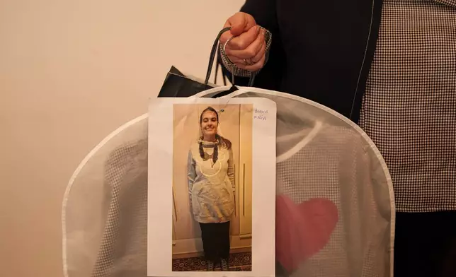 一名女子在SEEN匿名裁縫師慈善晚會前手持一套服裝。這是在2026年3月18日周三，世界唐氏綜合症日（3月21日）前夕，於羅馬尼亞首都布加勒斯特舉行的SEEN匿名裁縫師慈善晚會上拍攝。該活動由布加勒斯特唐氏綜合症加強協會（Down Plus Bucharest）組織，該協會是一個支援唐氏綜合症及其他智力障礙年輕人的非政府組織。(美聯社圖片/ Vadim Ghirda) AP圖片