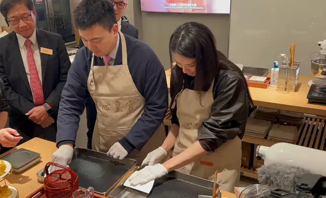 立法會議員江旻憓、梁進體驗製作芝麻卷。巴士的報記者攝