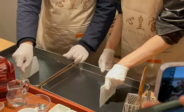 立法會議員江旻憓、梁進體驗製作芝麻卷。巴士的報記者攝