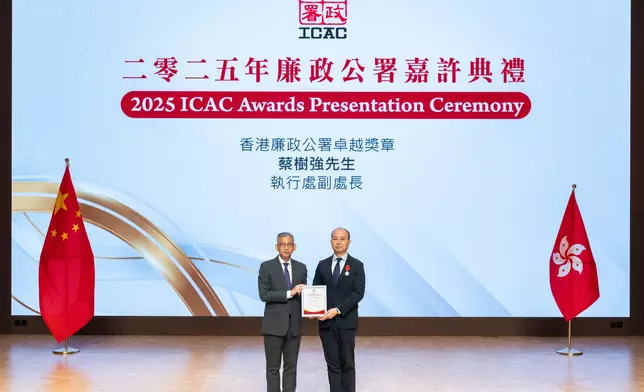 廉政專員胡英明(左)頒發紀念品予早前獲政府頒發廉政公署卓越獎章的執行處處長(政府部門)蔡樹強 (右)。廉署圖片