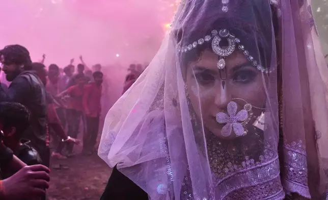 2026年2月27日，印度馬圖拉，灑紅節慶祝活動期間，一名跨性別社群成員在室利克里希納誕生地廟建築群內跳舞。(美聯社圖片/Manish Swarup) AP圖片