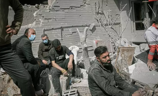 2026年3月24日周二，伊朗西北部東阿塞拜疆省塔布里茲，美國與以色列的軍事行動期間，一幢住宅大廈遭凌晨襲擊。志願者正在休息，救援人員則在檢查瓦礫並搜尋受害者。(美聯社圖片/Matin Hashemi) AP圖片