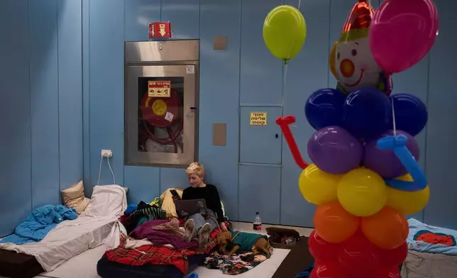 2026年3月2日周一，在猶太教節日普珥節（Purim）期間，以色列拉馬特甘（Ramat Gan）一個用作防空洞的地下地鐵站內，一名女子坐在床褥上，當時正受伊朗（Iran）可能導彈襲擊的威脅。(美聯社圖片/Oded Balilty) AP圖片