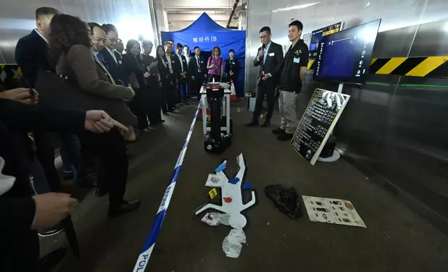 鑑證科人員在模擬案件現場展示高科技指紋掃描儀器