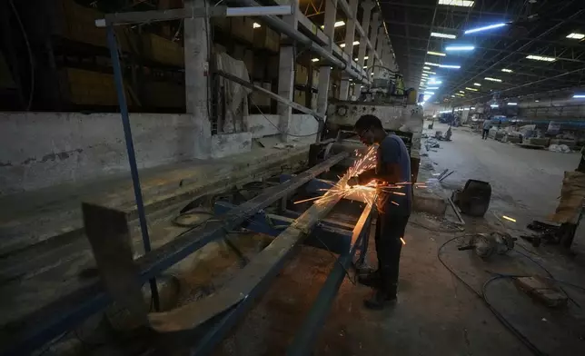 在印度古吉拉特邦莫爾比，一名男子在因燃料短缺而關閉的瓷磚廠內，於2026年4月8日周三對機器進行維修工作。(美聯社圖片/Ajit Solanki) AP圖片