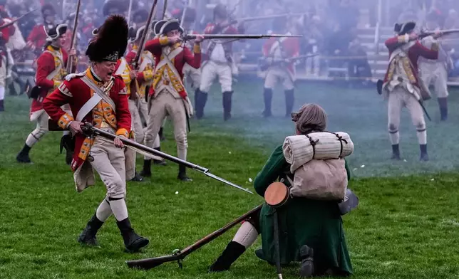 2026年4月18日周六，在麻省列星頓舉行的列星頓戰役歷史重演中，一名身穿紅色制服的英軍士兵（左）用刺刀刺向一名殖民地民兵。(美聯社圖片/Charles Krupa) AP圖片