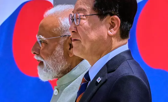印度總理莫迪（左）與南韓總統李在明，2026年4月20日周一在印度新德里步行前往代表團級別會議。(美聯社圖片/馬尼殊·斯瓦魯普) AP圖片