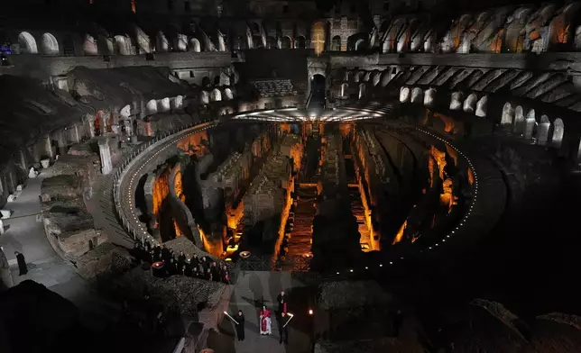 教宗利奧十四世於2026年4月3日周五，在羅馬鬥獸場舉行的苦路（Via Crucis）燭光耶穌受難日（Good Friday）遊行期間，背負一個輕巧的1.5米木製十字架，象徵性地重現耶穌基督在耶路撒冷各各他（Calvary）被釘十字架的歷程。(美聯社圖片/亞歷山德拉·塔蘭蒂諾 Alessandra Tarantino) AP圖片