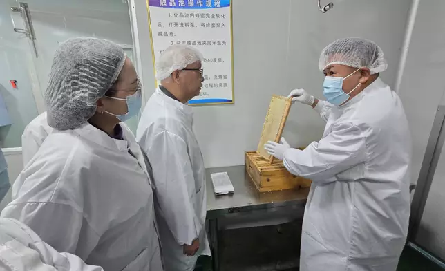 謝展寰（中）及環境及生態局常任秘書長（食物）楊碧筠（左）到訪西藏首間獲「出口蜂產品原料養殖場」資格的蜂蜜企業，了解該企業的蜂蜜處理與製作流程，以及蜂蜜供港的情況。政府新聞處圖片