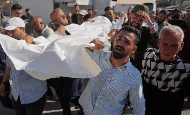 周二，2026年7月21日，巴勒斯坦哀悼者在加沙地帶代爾巴拉赫的葬禮上，抬著在以色列空襲中喪生的阿馬西家族成員遺體。 (美聯社圖片/Abdel Kareem Hana) AP圖片