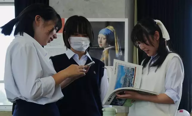 (美聯社圖片/Hiro Komae) 二零二六年七月二十一日周二，在東京西北部熊谷的熊谷女子高等學校，藝術學會新生正在討論粉筆藝術繪畫的構思，她們是參與全國黑板藝術比賽的團隊成員。 AP圖片