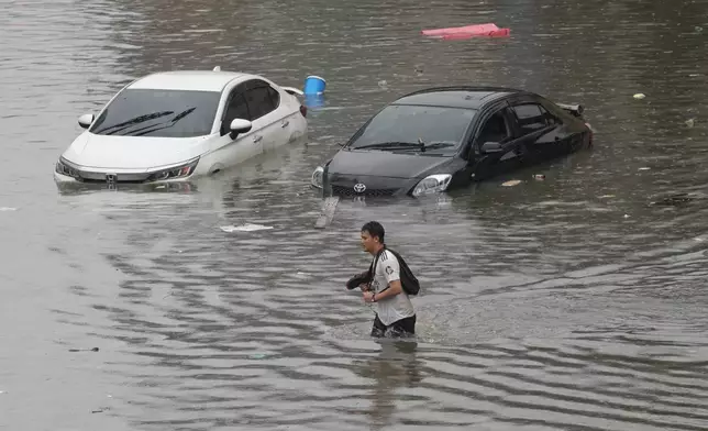 一名男子周六（2026年9月26日）在泰國曼谷大雨後的洪水中涉水而行。(美聯社圖片/Sakchai Lalit) AP圖片