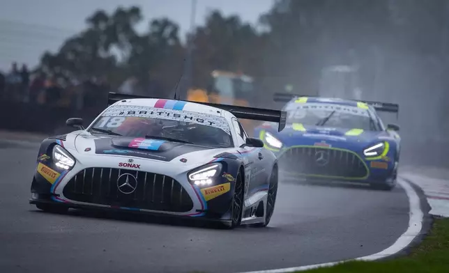 賽車在雨天的Donington Park賽道上亮起大燈極速過彎