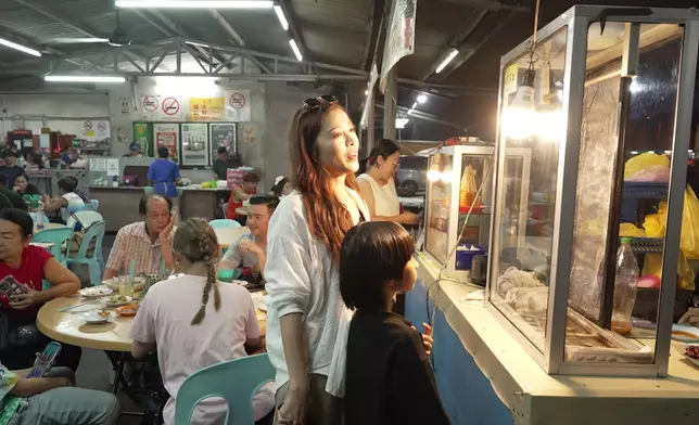 兩母子一抵埗便幫襯路邊攤，靠把口認識馬來西亞。