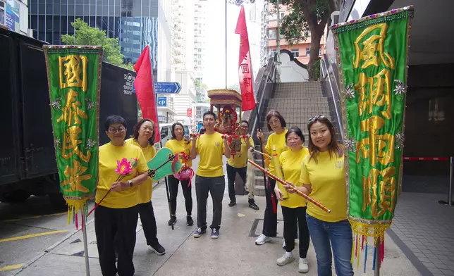 巡遊隊伍手持旗幟與神轎