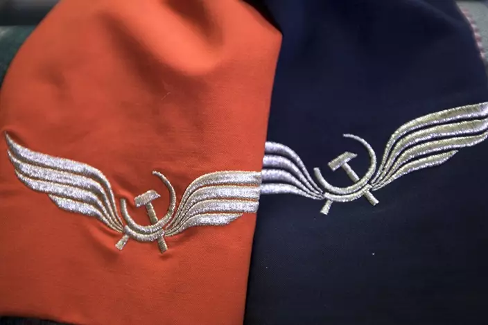 Aeroflot flight attendant Yevgeniya Magurina shows her summer and winter uniforms at her home. (AP Photo/Alexander Zemlianichenko)