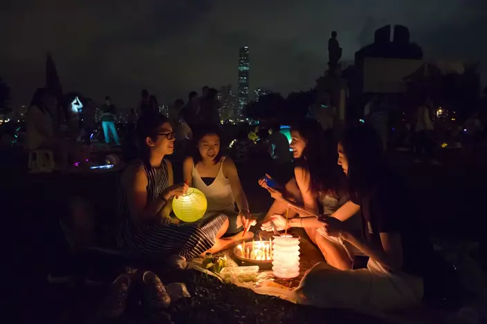 Residents light up lanterns at a park in Hong Kong to celebrate the Chinese Mid-Autumn Festival, Wednesday, Oct. 4, 2017. (AP Photo/Kin Cheung)