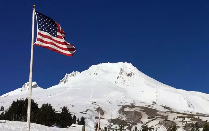 Oregon's Mount Hood is seen from Timberline Lodge on the south side of the mountain, Tuesday, Feb. 13, 2018. Authorities say a climber who fell up to 1,000 feet (305 meters) and was airlifted off Mount Hood has died. (AP Photo/Gillian Flaccus)