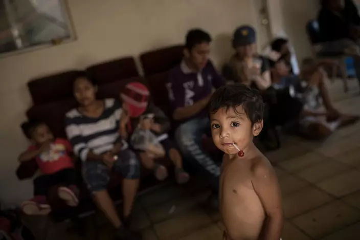 Central American migrants traveling with a caravan of Central American migrants wait to be registered at the Viña de Cristo shelter in Tijuana, Mexico, Wednesday, April 25, 2018. The caravan of mainly Central American migrants are planning to request asylum, either in the United States or Mexico. (AP Photo/Hans-Maximo Musielik)