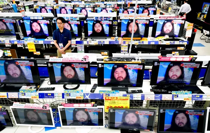 TV screens at an electrical appliance store show the image of doomsday cult leader Shoko Asahara in news reports, in Urayasu, near Tokyo, Friday, July 6, 2018. Asahara and six followers were executed Friday for their roles in a deadly 1995 gas attack on the Tokyo subways and other crimes, Japan’s Justice Ministry said. (Kyodo News via AP)