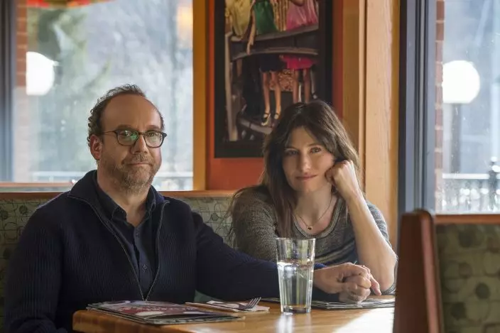 This image released by Netflix shows Paul Giamatti, left, and Kathryn Hahn in a scene from "Private Life." (Jojo WhildenNetflix via AP)