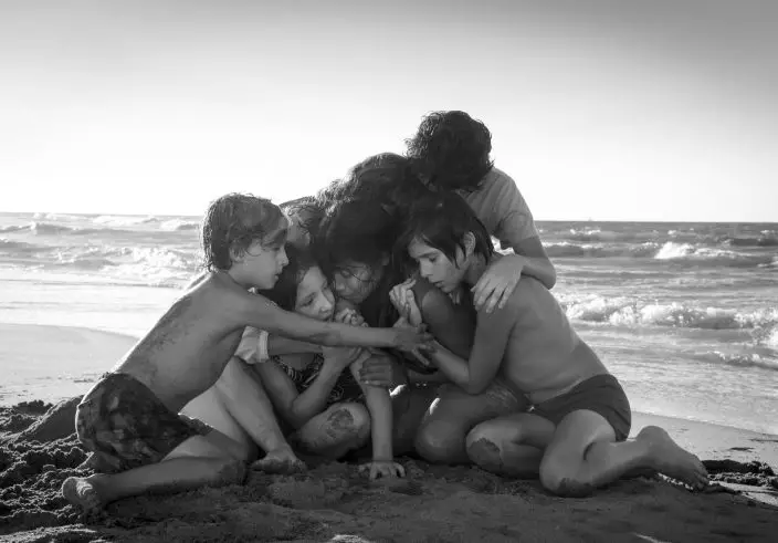 This image released by Netflix shows Yalitza Aparicio, center, in a scene from the film "Roma," by filmmaker Alfonso Cuaron. (Carlos SomonteNetflix via AP)