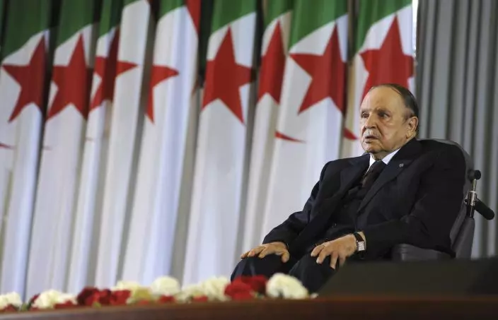FILE - In this April 28, 2014 file photo, Algerian President Abdelaziz Bouteflika sits on a wheelchair after taking the oath as President, in Algiers. Algeria's longtime leader Bouteflika has abandoned his bid for election to a fifth term in office, but has simultaneously postponed the election set for next month.(AP PhotoSidali Djarboub, File)