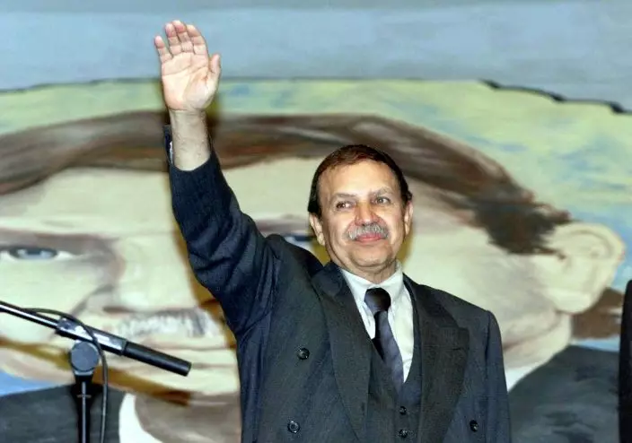 FILE - In this April 11, 1999 file photo, Algerian presidential candidate and former Foreign Minister Abdelaziz Bouteflika waves to supporters as he campaigns in Algiers, Sunday, April 11, 1999. Algeria's longtime leader Abdelaziz Bouteflika has abandoned his bid for election to a fifth term in office, but has simultaneously postponed the election set for next month. (AP PhotoLaurent Rebours, File)