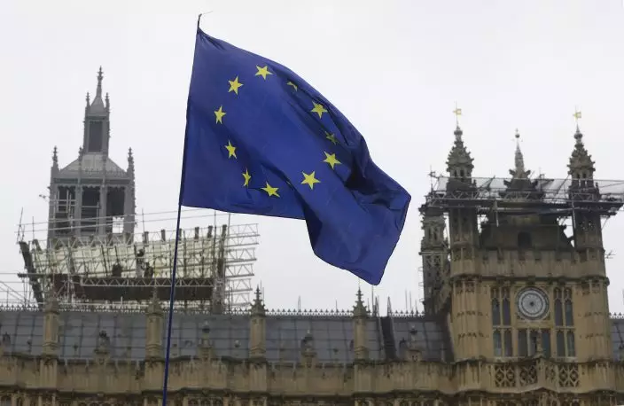 A European Union flag flies in front of Britain's parliament buildings as workmen carry out repairs, in London, Tuesday, April 9, 2019. Prime Minister Theresa May has brought her case for a further delay to Britain's departure from the European Union to Berlin, while German and French officials are insisting that any extension to the deadline must come with strings attached and assurances from London. (AP PhotoKirsty Wigglesworth)