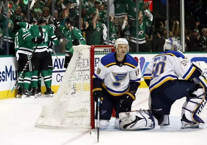 Teammates congratulate Dallas Stars' Tyler Seguin (91) on his goal as St. Louis Blues goaltender Jordan Binnington (50) and Jay Bouwmeester (19) kneel in front of the net during the first period in Game 6 of an NHL second-round hockey playoff series, Sunday, May 5, 2019, in Dallas. (AP PhotoTony Gutierrez)