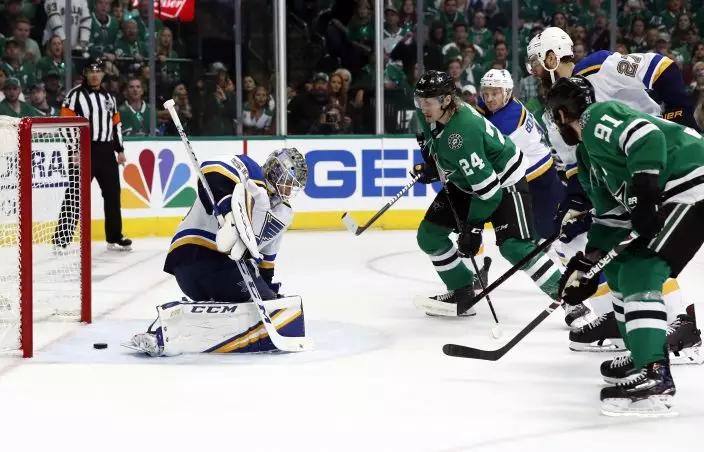 Dallas Stars' Tyler Seguin (91) scores past St. Louis Blues goaltender Jordan Binnington (50) as Stars' Roope Hintz (24) watches during the first period in Game 6 of an NHL second-round hockey playoff series, Sunday, May 5, 2019, in Dallas. (AP PhotoTony Gutierrez)