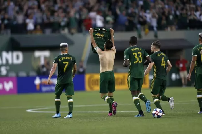 Portland Timbers' Diego Valeri (8) removes his shirt during the first half of an MLS soccer match against the LA Galaxy on Saturday, July 27, 2019, in Portland, Ore. (Noble GuyonThe Oregonian via AP)