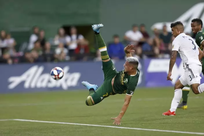 The Portland Timbers' Brian Fernandez (7) jumps for the ball during the first half of an MLS soccer match against the LA Galaxy in Portland, Ore., on Saturday, July 27, 2019. (Noble GuyonThe Oregonian via AP)
