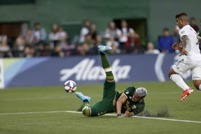 The Portland Timbers' Brian Fernandez (7) falls to the turf during the first half of an MLS soccer match against the LA Galaxy in Portland, Ore., on Saturday, July 27, 2019. (Noble GuyonThe Oregonian via AP)