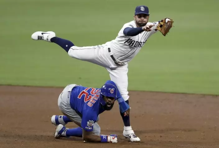 San Diego Padres second baseman Greg Garcia, above, watches his throw to first as Chicago Cubs' Jason Heyward (22) arrives late to second during the second inning of a baseball game Monday, Sept. 9, 2019, in San Diego. Chicago Cubs' Kyle Hendricks was safe at first on the play. (AP PhotoGregory Bull)