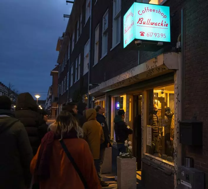 People queue to buy marijuana at coffeeshop Bulwackie in Amsterdam, Netherlands, Sunday, March 15, 2020, after a TV address of health minister Bruno Bruins who ordered all Dutch schools, cafes, restaurants, coffeeshops and sport clubs to be closed on Sunday as the government sought to prevent the further spread of coronavirus in the Netherlands. For most people, the new coronavirus causes only mild or moderate symptoms, such as fever and cough. For some, especially older adults and people with existing health problems, it can cause more severe illness, including pneumonia. (AP PhotoPeter Dejong)