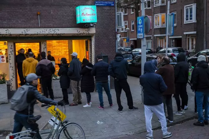 People queue to buy marijuana at coffeeshop Bulwackie in Amsterdam, Netherlands, Sunday, March 15, 2020, after a TV address of health minister Bruno Bruins who ordered all Dutch schools, cafes, restaurants, coffeeshops and sport clubs to be closed on Sunday as the government sought to prevent the further spread of coronavirus in the Netherlands. For most people, the new coronavirus causes only mild or moderate symptoms, such as fever and cough. For some, especially older adults and people with existing health problems, it can cause more severe illness, including pneumonia. (AP PhotoPeter Dejong)