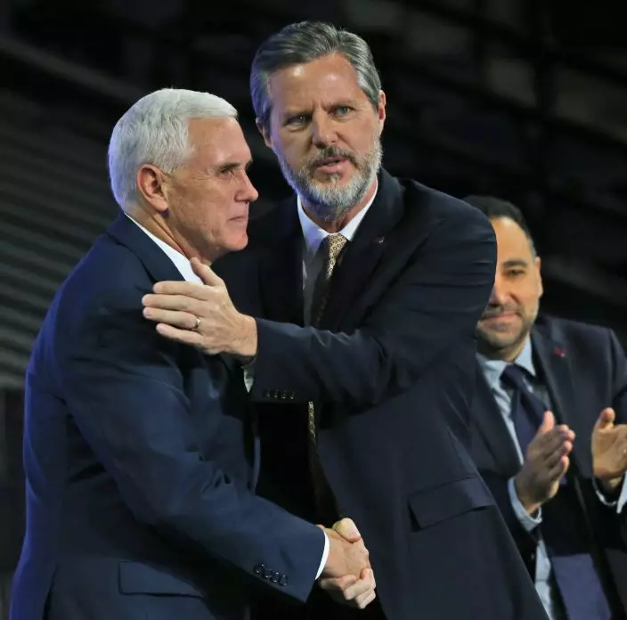 FILE - In this Wednesday, Oct. 12, 2016 file photo, Republican Vice Presidential candidate, Indiana Gov. Mike Pence, left, shakes hands with Liberty University President Jerry Falwell Jr., after speaking at the university in Lynchburg, Va. On Tuesday, Aug. 25, 2020, Falwell said that he has submitted his resignation as head of evangelical Liberty University. (AP PhotoSteve Helber)