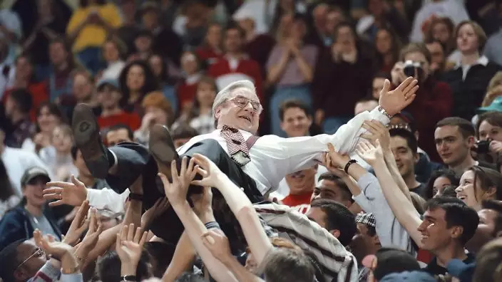 FILE - In this March 1 1997 file photo, the Rev. Jerry Falwell crowd surfs held by students during the Big South Tournament semifinal basketball game at the Vines Center, at Liberty University in Lynchburg, Va. On Tuesday, Aug. 25, 2020, his son, Jerry Falwell Jr., said that he has submitted his resignation as head of evangelical Liberty University. (Doug KoontzThe News & Advance via AP)