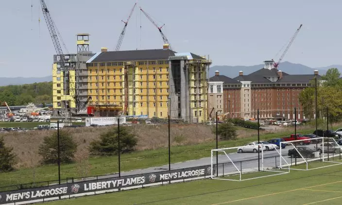 FILE - This Tuesday, April 21, 2015 file photo shows Liberty University's new nine story dorm expansion under construction in Lynchburg, Va., in the foothills of Virginia's Blue Ridge mountains. On Tuesday, Aug. 25, 2020, Jerry Falwell, Jr. said that he has submitted his resignation as head of evangelical Liberty University. (AP PhotoSteve Helber)