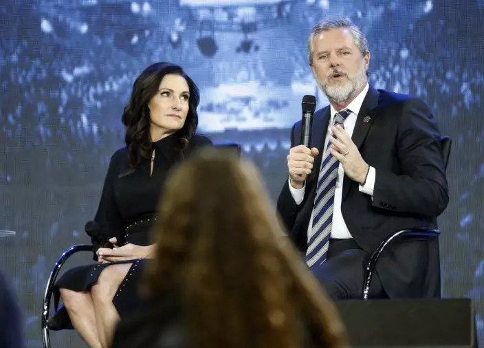 FILE - In this Wednesday, Nov. 28, 2018 file photo, Jerry Falwell Jr., right, answers a student's question accompanied by his wife, Becki, during after a town hall on the opioid crisis at a convocation at Liberty University in Lynchburg, Va. On Tuesday, Aug. 25, 2020, Falwell said that he has submitted his resignation as head of evangelical Liberty University. (AP PhotoSteve Helber)