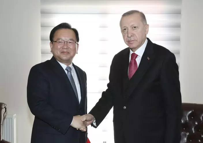 Turkey's President Recep Tayyip Erdogan, right, and South Korean PM Kim Boo-kyum shake hands before a meeting in Çanakkale, western Turkey, Friday, March 18, 2022. Kim will attend the opening ceremony of the Canakkale Bridge later in the day. (Turkish Presidency via AP)