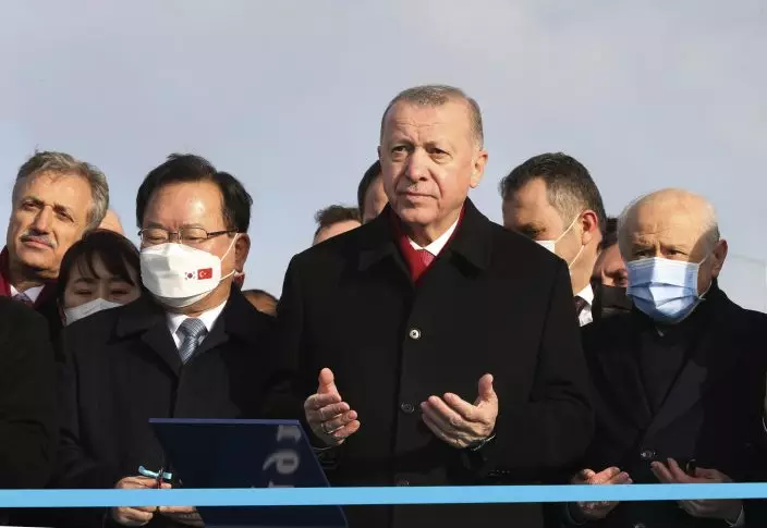 Turkey's President Recep Tayyip Erdogan, center, and South Korean PM Kim Boo-kyum, left, attend the opening ceremony of the 1915 Canakkale Bridge, in Çanakkale, western Turkey, Friday, March 18, 2022. The bridge links the Asian side of Turkey with European side over Dardanelles Strait. (Turkish Presidency via AP)