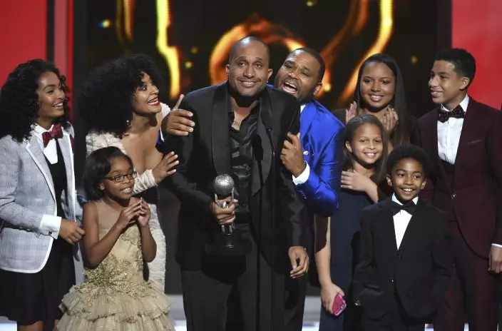 FILE - Show creator Kenya Barris, center, and the cast and crew of "Black-ish" accept the award for outstanding comedy series at the 46th NAACP Image Awards on Feb. 6, 2015, in Pasadena, Calif. The series put an affluent and devoted family of color at the center of attention and let Black creators tell their stories. The series finale airs Tuesday, April 19. (Photo by Chris PizzelloInvisionAP, File)