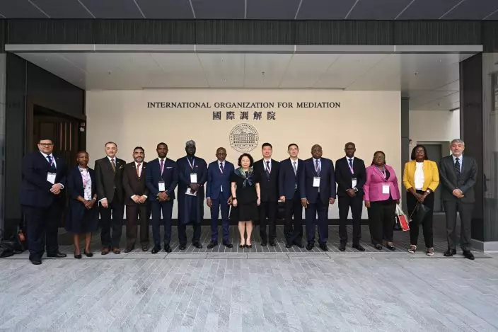 A delegation of 13 overseas government officials completed its visit to Hong Kong today (May 29). Photo shows the Secretary-General of the International Organization for Mediation, Professor Teresa Cheng (centre), with the delegation. Source: HKSAR Government Press Releases